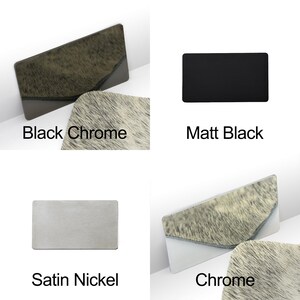 May include: Four rectangular objects with different finishes are displayed. The finishes include Black Chrome, Matt Black, Satin Nickel, and Chrome. The text labels each finish. The Black Chrome and Chrome finishes have a textured, animal-like pattern.