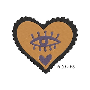 Peut inclure: Un patch en forme de cœur brun avec un œil violet et un petit cœur violet au centre. Le cœur est bordé de noir.