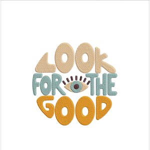 Pu&ograve; includere: Disegno ricamato con il testo "Look for the good" in un cerchio con un occhio stilizzato al centro. Il testo &egrave; in giallo, arancione e blu. L'occhio &egrave; blu con una pupilla nera e ciglia.