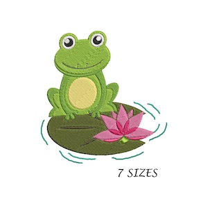 May include: Green frog sitting on a lily pad with a pink flower. The frog has big eyes and a smile. The lily pad is green and has a light blue water ripple effect around it. 7 SIZES
