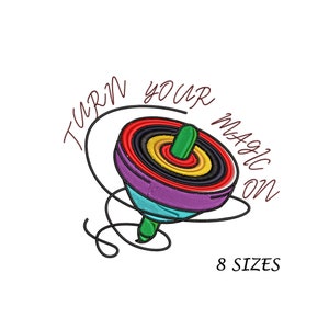 May include: Embroidered design of a colourful spinning top with the text "TURN YOUR MAGIC ON" in a curved arc. The top features layers of red, black, yellow, and purple. The text "8 SIZES" is below the spinning top.