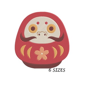 May include: Red and white daruma doll with a flower design and the text "6 SIZES" on the bottom.