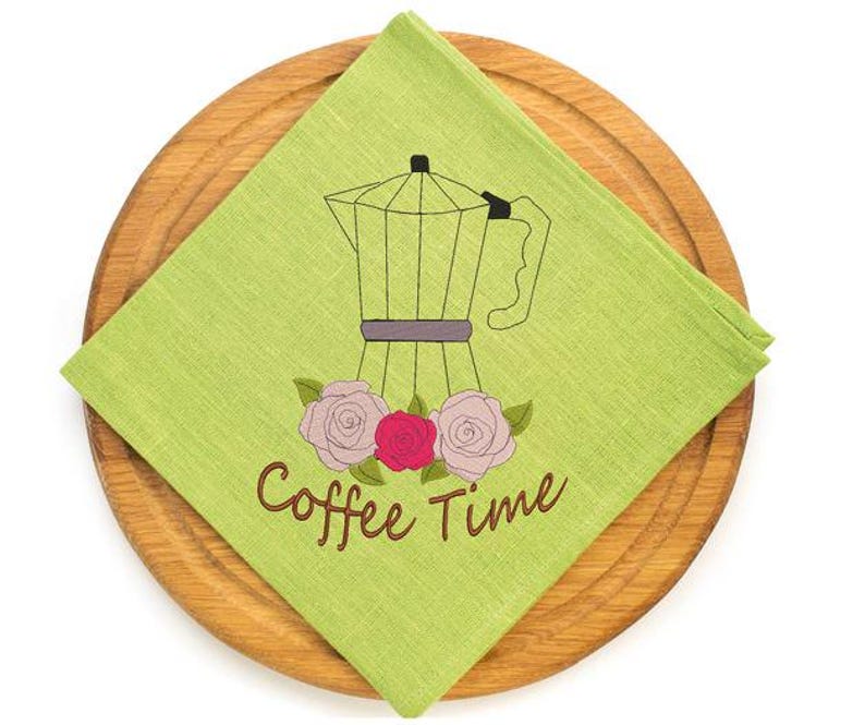 May include: A lime green square napkin with a coffee pot illustration and the words "Coffee Time" in brown script. The napkin is on a round wooden serving board. The coffee pot is black and gray with pink and red roses.