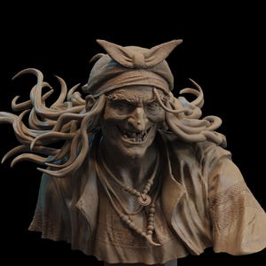 May include: A detailed bust of a wizened, smiling figure with long, flowing hair and a headscarf. The figure wears a necklace and a detailed jacket. The sculpture is a neutral beige color against a black background.