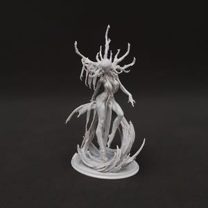 May include: A gray figurine of a female figure with a crown of branches and flowing fabric. The figure is standing on a base with a swirling design, arms outstretched. The sculpture is detailed and appears to be made of resin.
