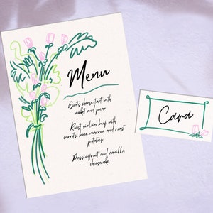 May include: A white menu card with a green floral illustration and the text "Menu" in black. The menu lists "Goats cheese tart with rocket and pear", "Roast sirloin beef with carrots, bone marrow and roast potatoes", and "Passionfruit and vanilla cheesecake". A white place card with a green border and the text "Cara" in black is also shown.
