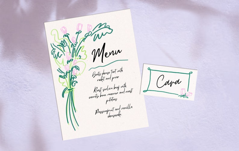 May include: A white menu card with a green floral illustration and the text "Menu" in black. The menu lists "Goats cheese tart with rocket and pear", "Roast sirloin beef with carrots, bone marrow and roast potatoes", and "Passionfruit and vanilla cheesecake". A white place card with a green border and the text "Cara" in black is also shown.