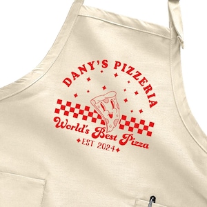 May include: A beige apron with a red logo that says "Danny's Pizzeria" with a pizza slice graphic and the text "World's Best Pizza Est 2024".