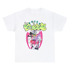 Puede incluir: Camiseta blanca con un estampado gráfico de un diseño abstracto colorido con la palabra "S.C.U.M." en letras verdes y blancas.