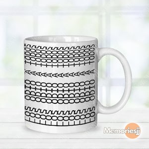 May include: White ceramic mug with a black and white stitched pattern design. The design includes various stitch styles, such as chain stitches, running stitches, and triangle stitches. The mug has a curved handle and is suitable for hot or cold drinks.