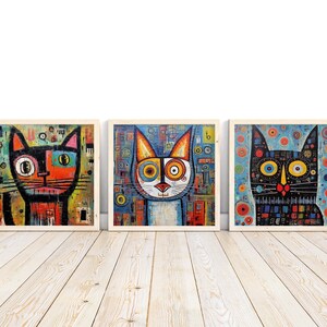 Puede incluir: Tres pinturas enmarcadas de gatos estilizados y coloridos con ojos grandes. Los gatos están representados en un estilo caprichoso y abstracto con patrones geométricos y colores brillantes.