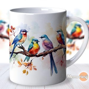 May include: White ceramic mug featuring a watercolour design of four colourful birds perched on branches with autumn leaves. The birds are blue, green, purple, and orange.