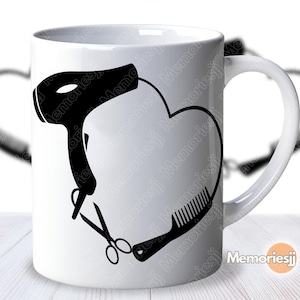 May include: White ceramic mug with a black heart-shaped design incorporating a hairdryer, scissors, and a comb. The mug has a white handle and is suitable for hot or cold drinks. The design is a silhouette of hairstyling tools.