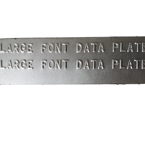 May include: A silver metal data plate with the text "LARGE FONT DATA PLATE" embossed on it twice.
