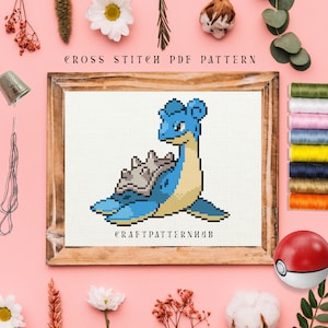 Puede incluir: Un patrón de punto de cruz con un personaje Pokemon azul y marrón, Blastoise, en un marco de madera. El patrón se titula "Craft Pattern Hub".