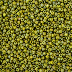 May include: A close-up image of a large quantity of small, round, green beads. The beads have a slightly iridescent finish, giving them a subtle shimmer.