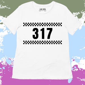 May include: White t-shirt with a black checkered border and the number 317 in black.