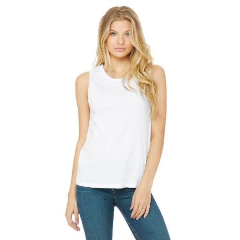 May include: A white sleeveless tank top made of a soft material. The top is paired with blue jeans. The model is standing in front of a white background.