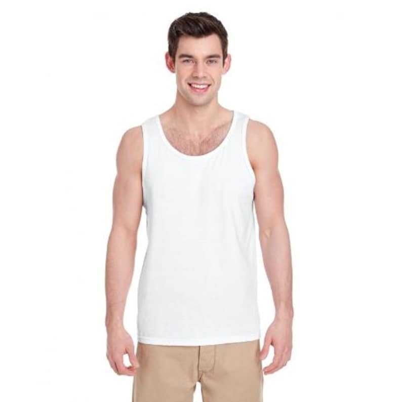 May include: A white tank top with a rounded neckline. The sleeveless shirt is made of a soft material. The model is wearing khaki-colored pants.