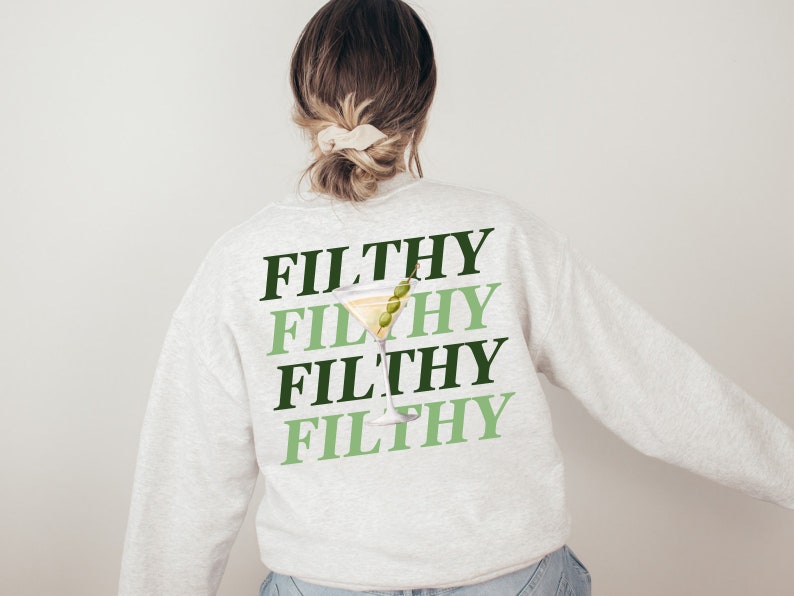 May include: A light gray sweatshirt with the word "FILTHY" repeated four times in black and green lettering. A green olive and a martini glass are superimposed on the word "FILTHY".