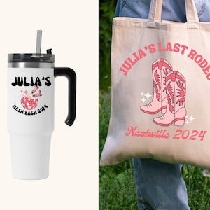 May include: A white tote bag with the text "Julia's Last Rodeo Nashville 2024" and a pink illustration of two cowboy boots. A white travel mug with a black handle and the text "Julia's Nash Bash 2024" and a pink illustration of a disco ball with cowboy boots.