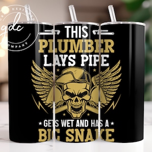 May include: A black and gold tumbler with the text "This plumber lays pipe *gets wet and has a big snake*" on it. The tumbler has a skull with wings and a wrench on each side of the skull.