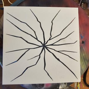 May include: Square canvas with a white background featuring a black, starburst-like design. The design consists of numerous jagged lines radiating outwards from a central point, resembling cracks or fractures.