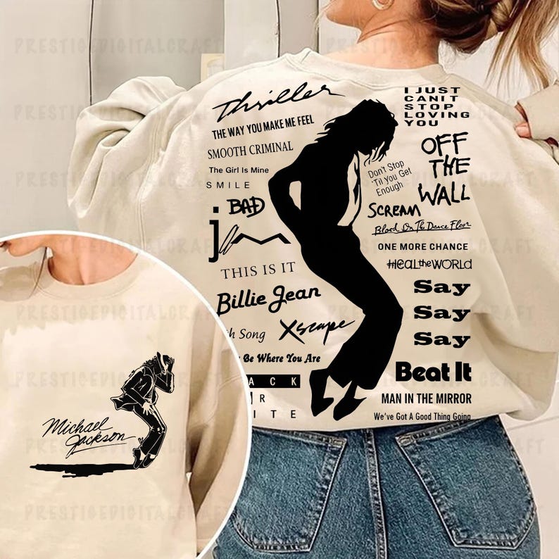 K&ouml;nnte beinhalten: Cremefarbenes Sweatshirt mit einer schwarzen Silhouette eines T&auml;nzers und Songtiteln wie "Thriller" und "Billie Jean". Das Design enth&auml;lt den Text "Michael Jackson" und andere Songtitel. Ein kleineres Bild des T&auml;nzers befindet sich auf der Vorderseite.