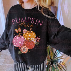 May include: Black sweatshirt with a pink and white graphic of pumpkins and the text "Pumpkin Patch".