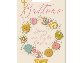 Könnte beinhalten: Eine Karte mit dem Wort "Buttons" in rosa Schrift und einer Sammlung von 10 stoffbezogenen Knöpfen in Pastellfarben mit floralen und geometrischen Mustern. Die Karte trägt den Schriftzug "Spring and Easter Pastels" und "Tilda" in der rechten unteren Ecke.