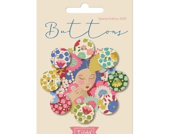May include: A package of decorative buttons with floral patterns in various colors. The buttons are arranged around a central illustration of a woman's face surrounded by flowers. The word "Buttons" is written in cursive, with "Special Edition 2025" above it.