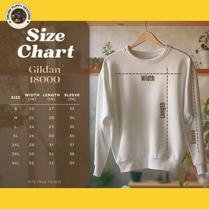 May include: Size chart for Gildan 18000 sweatshirts, showing width, length, and sleeve measurements in inches for sizes S through 4XL. The chart is displayed on a brown background with a white sweatshirt hanging on a hanger.