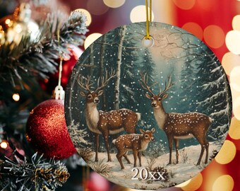 May include: Round Christmas ornament featuring a winter scene with three deer in a snowy forest. The ornament has a gold string for hanging and the year "20xx" printed at the bottom. The background is a snowy forest.