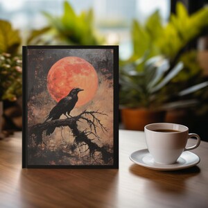 May include: A black crow perched on a bare branch against a backdrop of a large, red, full moon. The image has a dark, moody, and atmospheric feel.