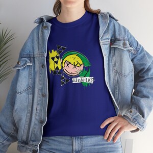 May include: A royal blue t-shirt with a green, yellow, and black graphic of Link from the Legend of Zelda video game series. The graphic is stylized with a graffiti-like design and includes the text "Link-182".