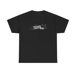 May include: Black t-shirt with a white graphic of a rocket ship with the text "Jive Cafe" on it.