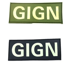 May include: Two rectangular patches with the word "GIGN" in white letters. The top patch is green and the bottom patch is black.