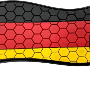 May include: A German flag patch with a honeycomb pattern. The flag is black, red and yellow.