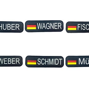 May include: Six black rectangular name tags with the German flag printed on the left side and white text on the right side. The names are Huber, Wagner, Fischer, Weber, Schmidt, and Müller.