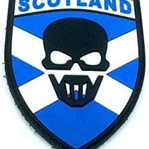 May include: A blue and white patch with a skull and crossbones design. The patch has the word "SCOTLAND" printed in white letters on a blue background.