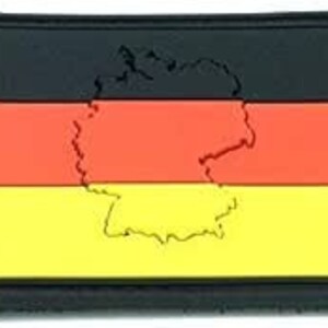 May include: Black, red and yellow fabric patch with the outline of Germany in the centre. The patch is a German flag with the outline of the country.