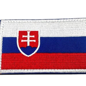 May include: A rectangular embroidered patch featuring the national flag of Slovakia. The design consists of three horizontal stripes in white, blue, and red, with the Slovak coat of arms centred on the left side, featuring a white double cross.