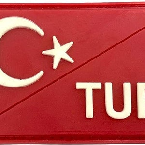May include: Red fabric patch with a white crescent moon and star, and the word "TUR" in white letters.