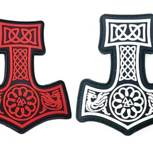 May include: Two embroidered patches in the shape of a hammer with a Celtic knot design. One patch is red and the other is white.