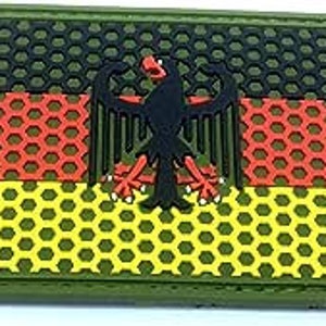 May include: A black, red and yellow German flag patch with a black eagle in the centre. The flag is on a green camouflage background.