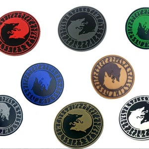 May include: Ten round embroidered patches featuring two wolves facing each other in a circle with runes around the outside. The patches are in various colours including red, green, blue, brown, grey, and white.