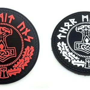 May include: Two black and white round patches with a black and white image of a hammer and a wreath of leaves. The text "THNR MIT NXS" is around the image. One patch has red accents.