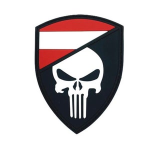 May include: A black and white skull patch with a red and white stripe across the top. The skull is a stylized version of the Punisher logo.