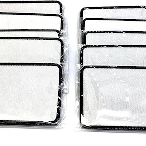 May include: Ten white iron-on patches with black borders, packaged in clear plastic.