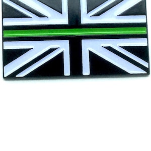 May include: A Union Jack flag with a thin green stripe across the middle.